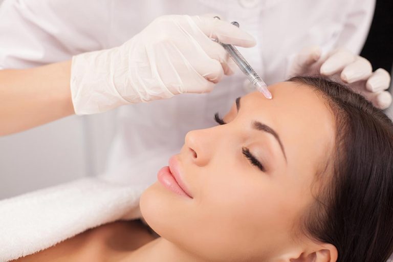 Woman having an injectable filler procedure on her forehead