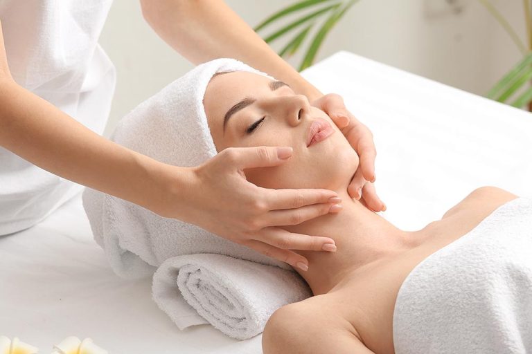 Woman enjoying a facial massage at a spa